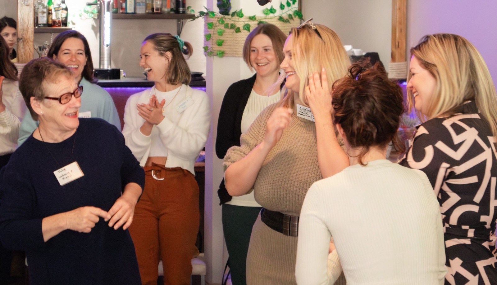 Women laughing and clapping together